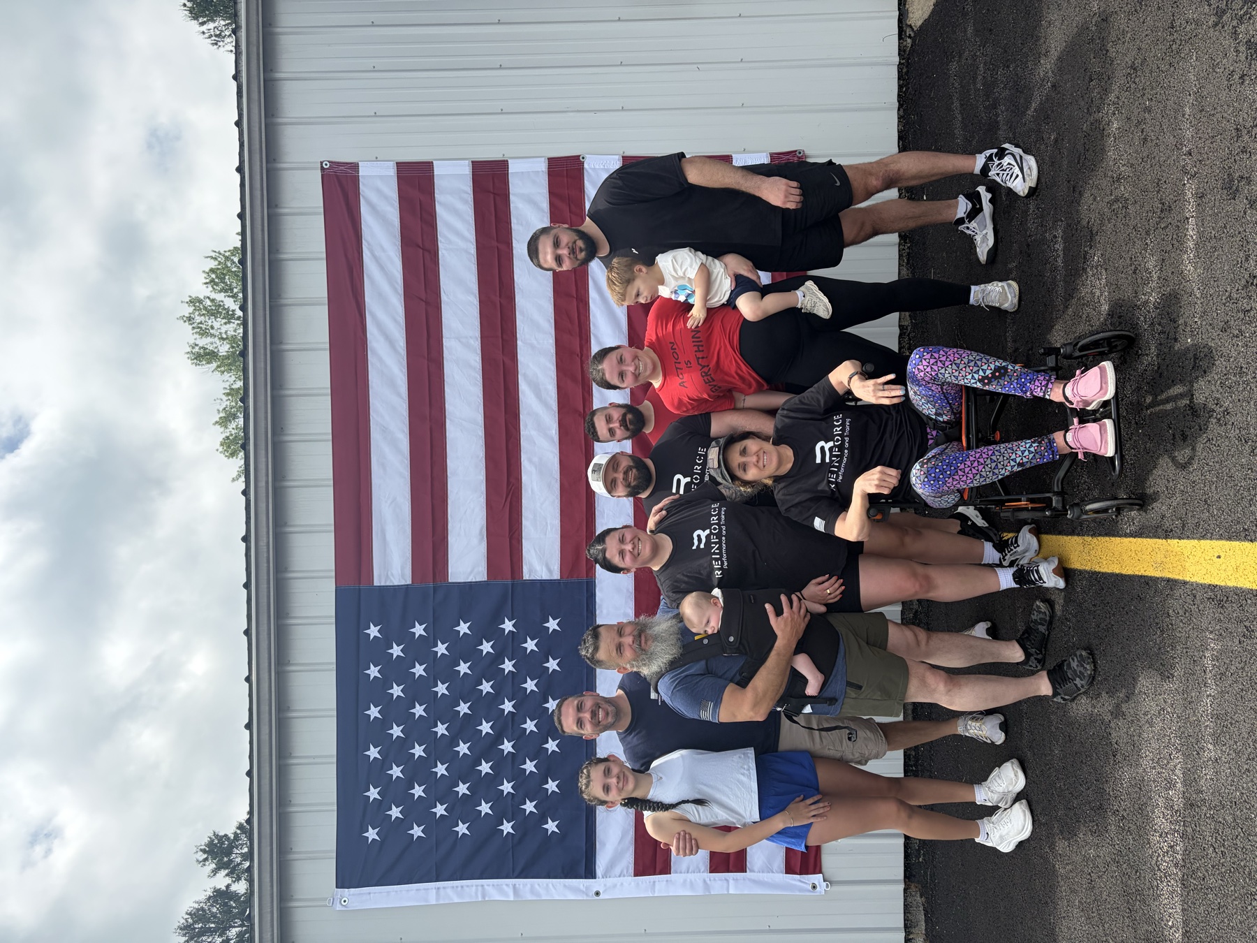 Reinforce members and supporters gathered beneath an American flag